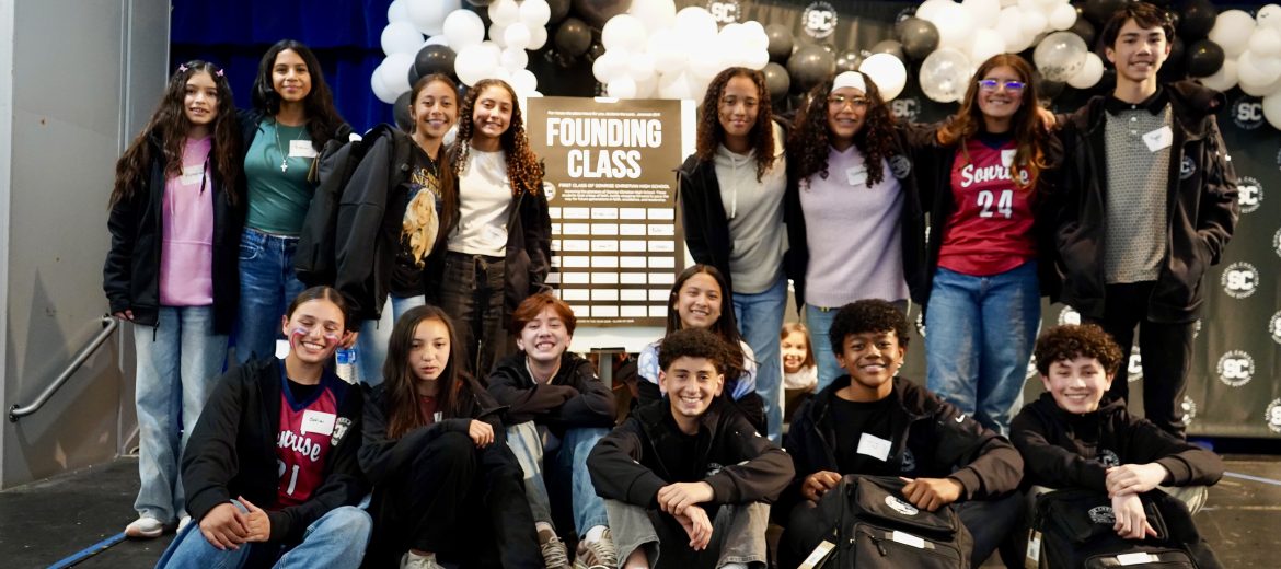 Founding class of Sonrise Christian High School posing together around the Founders Signing Board