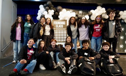 Founding class of Sonrise Christian High School posing together around the Founders Signing Board