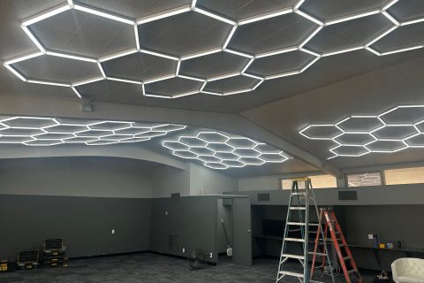 Modern hexagon honeycomb lighting installed in The Hub student center at Sonrise Christian High School, creating a warm and inviting atmosphere for high school students.