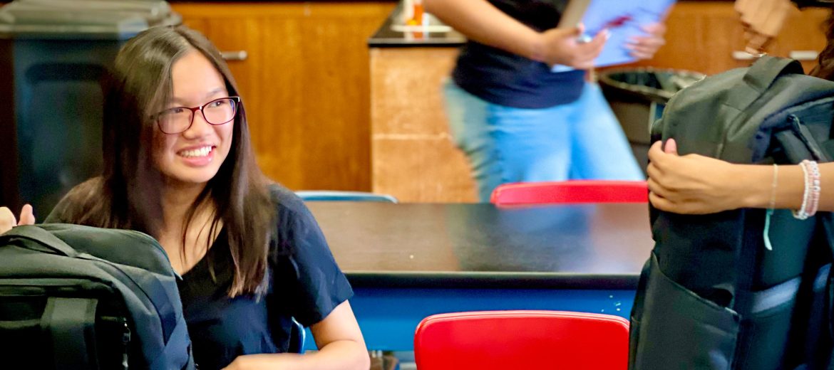 Student laughing in class, enjoying a fun and engaging learning moment